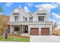 Two-story home with gray siding, brown garage doors, and landscaping at Lot 2 Glenview Meadow Dr # Savanh, Waxhaw, NC 28173