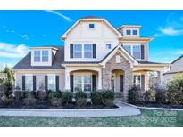 Two-story house with stone accents and a landscaped yard at 1022 Torrens Dr # 4, Monroe, NC 28110