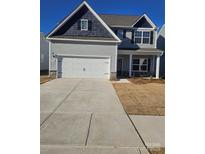 Two-story house with gray siding, white garage door, and stone accents at 1420 Nia Rd, Charlotte, NC 28215