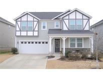 Two-story house with gray siding, white trim, and a welcoming front porch at 19117 Hawk Haven Ln, Charlotte, NC 28278