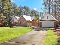 Brick home with attached garage and spacious driveway at 2044 Standing Timber Rd, Lancaster, SC 29720