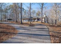 House exterior featuring a carport and long driveway at 209 Meadowridge Dr, Maiden, NC 28650