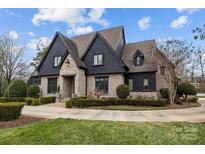 Stunning two-story home with stone and dark siding at 2130 Ferncliff Rd, Charlotte, NC 28211