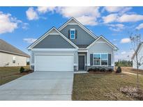 Gray siding ranch home with a two-car garage and landscaped lawn at 2234 Catawba Trace Dr, Catawba, NC 28609