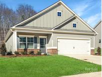 Single-story house with gray siding, brick accents, and a two-car garage at 2242 Catawba Trace Dr, Catawba, NC 28609