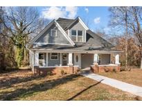 Charming craftsman home with gray siding, brick accents, and a welcoming front porch at 336 3Rd Se St, Hickory, NC 28602