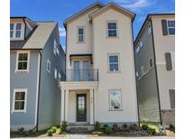 Charming two-story home with a front porch and balcony on a sunny day at 425 Delburg Mill Alley Dr, Davidson, NC 28036