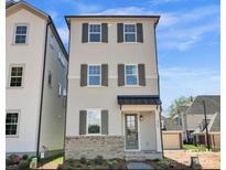 Charming new construction with Hardie Board siding and brick base, accented by shutters and a covered entry at 429 Delburg Mill Alley Dr, Davidson, NC 28036