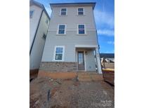 Three story home featuring beautiful blue siding and a brick foundation, steps to the covered front door at 429 Delburg Mill Alley Dr, Davidson, NC 28036