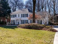 Two-story white house with blue shutters, landscaping, and a driveway at 4342 Arborway None, Charlotte, NC 28211