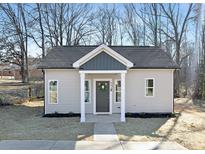 Newly constructed light beige house with dark gray accents and a welcoming front porch at 602 York Ave, Statesville, NC 28677