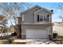 Two-story house with gray siding, attached garage, and landscaping at 9112 Meadowmont View Dr, Charlotte, NC 28269