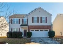 Two-story house with brick and siding, a two-car garage, and landscaping at 11906 Bending Branch Rd, Charlotte, NC 28227