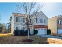 Two-story house with brick and siding, attached garage, and landscaping at 11906 Bending Branch Rd, Charlotte, NC 28227