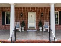 Inviting front porch with rocking chairs and brick facade at 210 W Glenview Dr, Salisbury, NC 28147