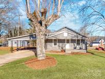 Gray house with carport and landscaped lawn at 701 Hiddenite Church Rd, Hiddenite, NC 28636