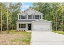 Two-story house with gray siding, white trim, and a two-car garage at 7601 Boswell Rd, Charlotte, NC 28215