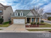Brick front home with a two-car garage and landscaping at 867 Pecan Tree Ln, Fort Mill, SC 29715