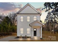 Charming two-story home with white siding and classic architectural details at 1310 Essex St, Gastonia, NC 28052