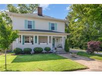 Charming two-story home with a welcoming front porch, lush green lawn, and mature landscaping at 132 N Confederate Ave, Rock Hill, SC 29730