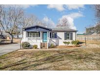 Charming ranch home with white brick, black accents, and a landscaped yard at 210 Dixie Dr, Kannapolis, NC 28083