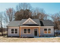 Charming single-story home featuring a covered porch with natural wood pillars and gray siding at 2222 Badin Rd, Albemarle, NC 28001