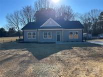 Newly constructed home featuring gray siding, a front porch, and a spacious yard at 2222 Badin Rd, Albemarle, NC 28001