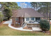 House back view with large deck and surrounding trees at 302 Mccrary Rd, Mooresville, NC 28117