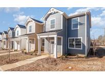 New construction townhome with gray siding and white trim at 336 D Lincoln St, Concord, NC 28025