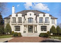Stunning two-story brick home with a classic design and landscaped grounds at 413 Eastover Rd, Charlotte, NC 28207