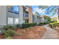 Exterior view of a condo building with walkway and landscaping at 5020 Sardis Rd, Charlotte, NC 28270