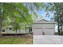 Charming home with a two-car garage, well-maintained lawn and an inviting front entrance at 10912 Treebark Dr, Charlotte, NC 28226