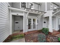 Gray townhome exterior with double front doors and small porch at 1208 Piedmont St, Charlotte, NC 28204