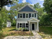 Charming two-story home featuring a covered front porch and a well-maintained lawn at 129 Sharon Rd, York, SC 29745