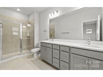 Modern bathroom with double vanity and a large shower at 2314 Donnelly Hills Ln, Charlotte, NC 28262