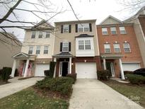 Brick front townhouse with 2-car garage and landscaping at 2653 Early Flight Dr, Charlotte, NC 28262