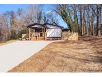 Charming craftsman style home with a wooden front porch and landscaped yard at 277 Melrose Sw Dr, Concord, NC 28025