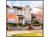 Tan two-story house with white picket fence and landscaping at 6033 Creft Cir, Indian Trail, NC 28079