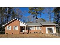 Brick ranch house with attached garage and landscaped yard at 625 Teddar Rd, Mount Gilead, NC 27306