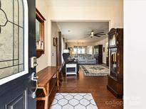 Inviting foyer with hardwood floors, decorative rug, and traditional grandfather clock at 8024 Carolina Lakes Way, Fort Mill, SC 29707