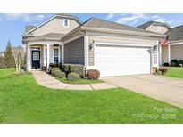 Charming single-story home featuring a two-car garage, well-maintained lawn, and inviting front entrance at 8024 Carolina Lakes Way, Fort Mill, SC 29707