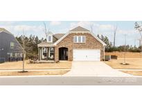 Inviting ranch home with stone accents and a two-car garage at 9009 Powder Works Dr, Huntersville, NC 28078