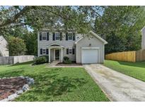 Two-story house with gray siding, a white door, and a two-car garage at 9022 Belle Bragg Way, Charlotte, NC 28214