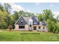 Two-story home with gray and white exterior, brick accents, and a landscaped lawn at Lot 6 Holbrook Rd, Fort Mill, SC 29715