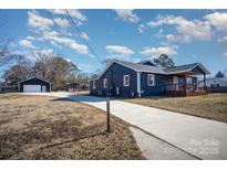 Newly renovated home with a long driveway, detached garage, and modern exterior at 110 Hubbard St, Belmont, NC 28012