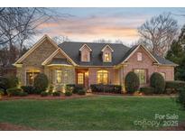 Brick front home with stone accents and landscaped lawn at 1101 Churchill Downs Dr, Waxhaw, NC 28173