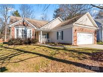 Brick ranch house with a two-car garage and landscaping at 11104 Fox Cove Dr, Charlotte, NC 28273