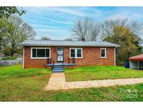 Brick ranch house with landscaped yard and walkway at 2752 21St Ne St, Hickory, NC 28601