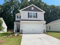 Two-story house with gray and white siding, a two-car garage, and landscaping at 3258 Clover Valley Dr, Gastonia, NC 28052