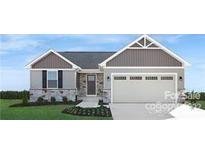 Two-story house with gray siding, stone accents, and a two-car garage at 421 Grandiflora Ave # 0084, Lancaster, SC 29720